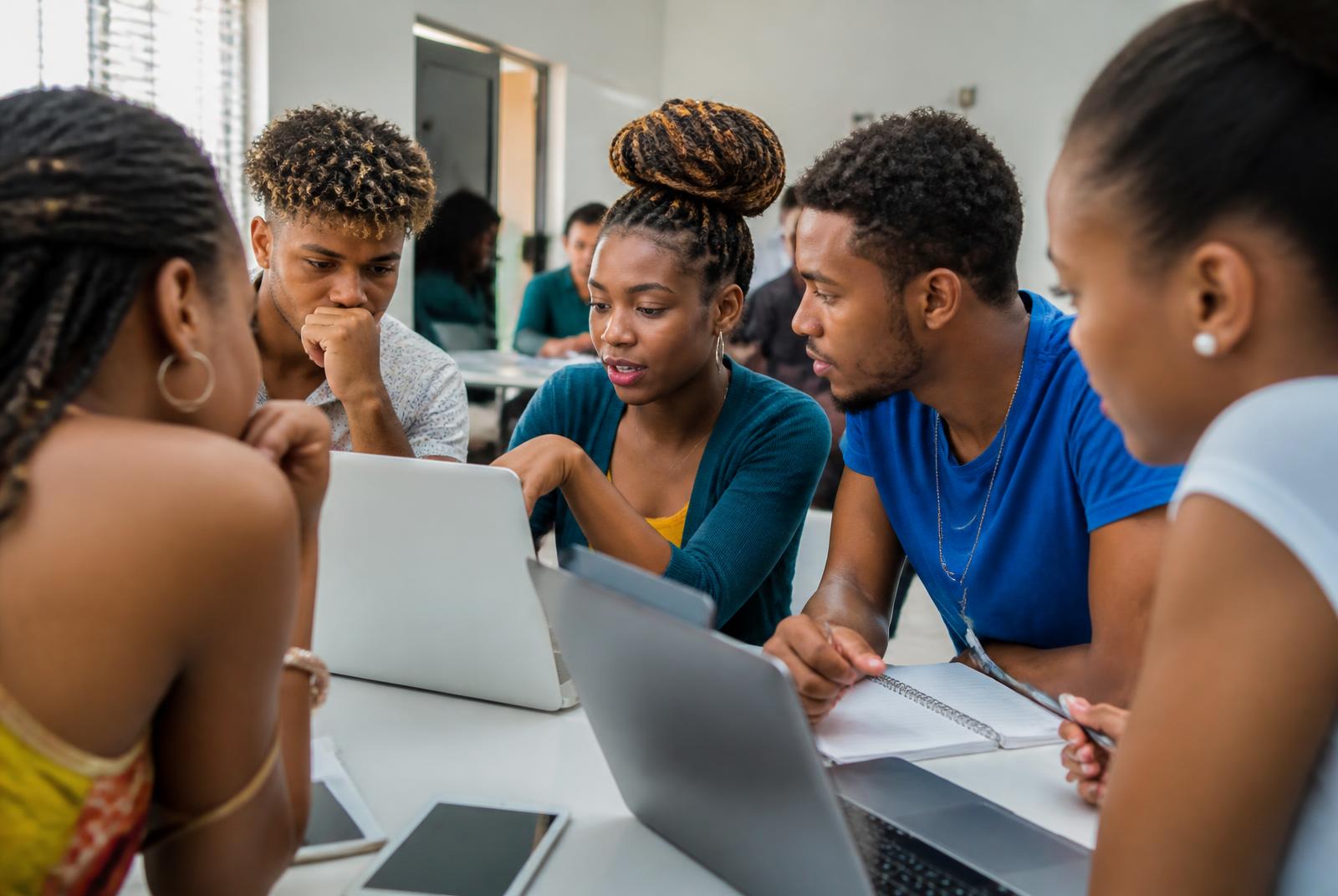 Young Caribbean entrepreneurs collaborating during an AI and business training session