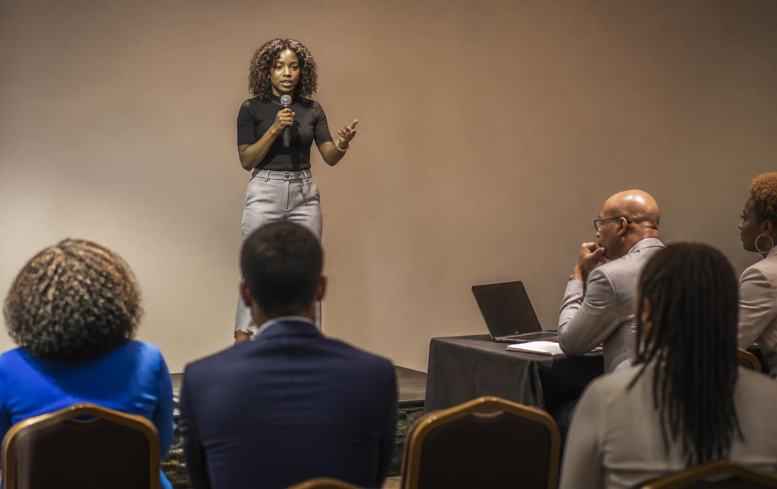 A founder pitching her business live to a panel and an audience